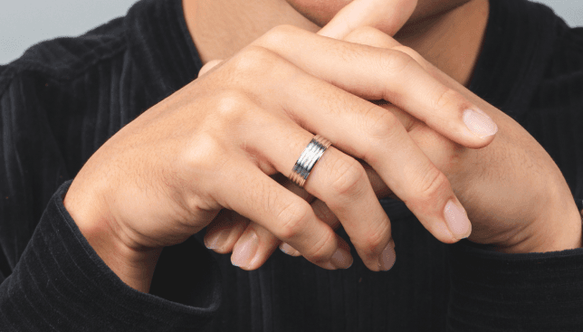 Man wearing engagement rings.